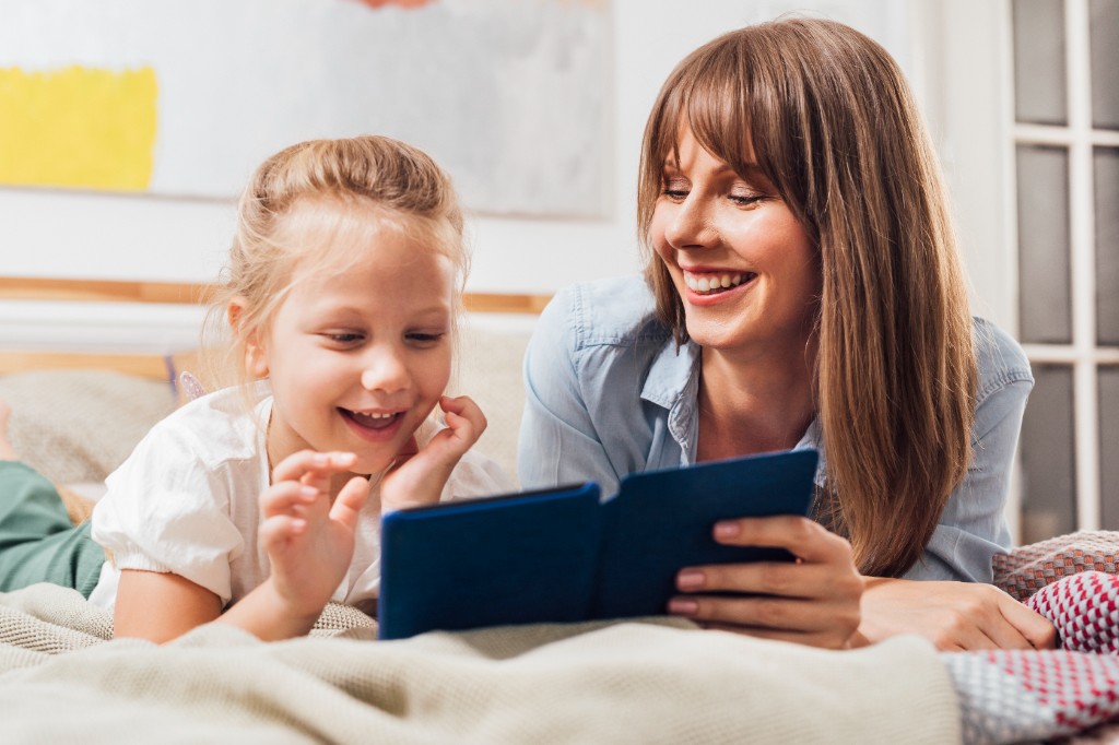 Mother and child reading together at home